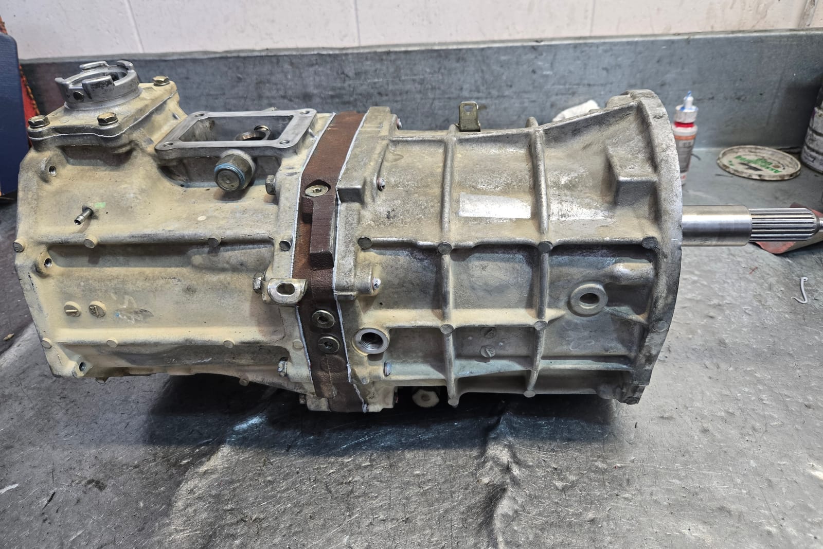 A complete manual gearbox on the workshop bench at The Gearbox Company, bellhousing to extension housing