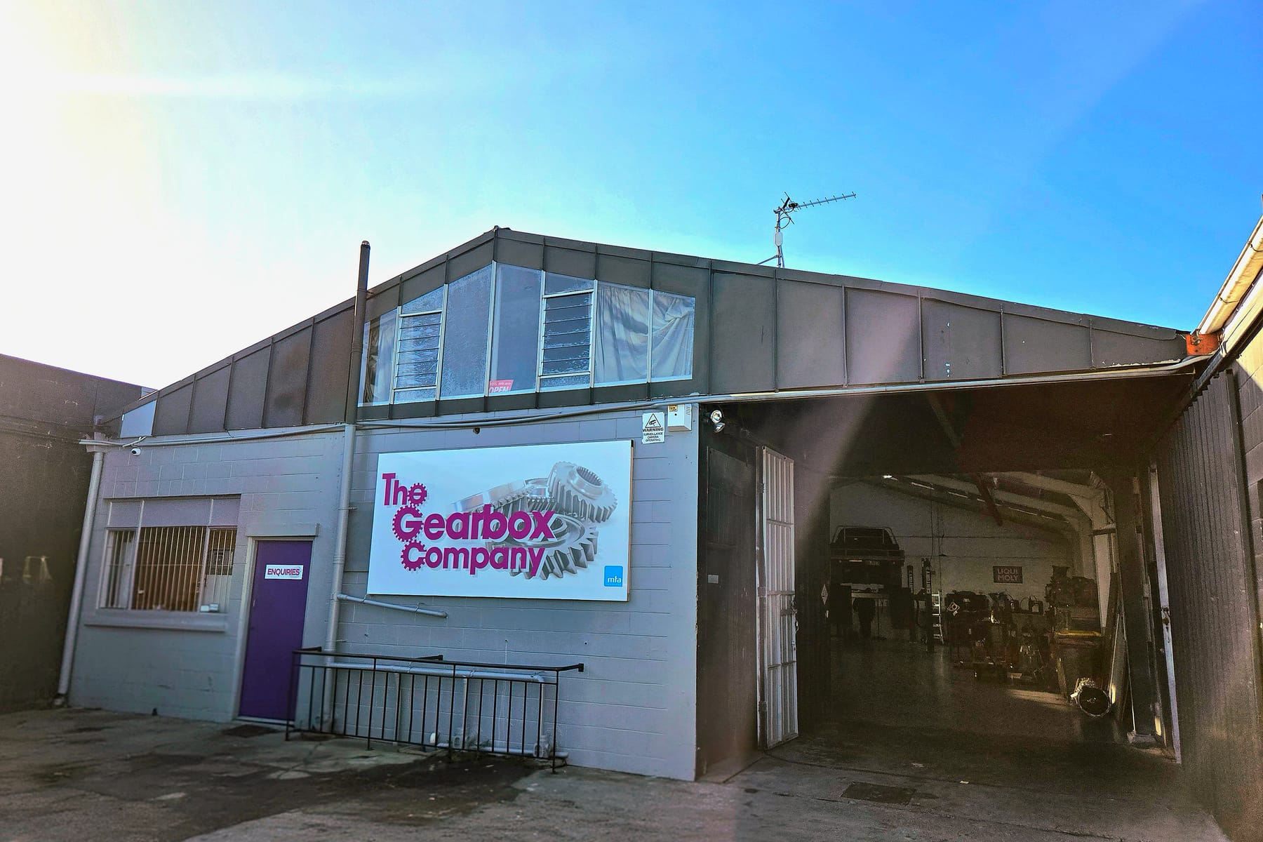 The Gearbox Company workshop at 156 Antigua Street, Addington - the sign on the wall, the enquiries door and the roller door open onto the hoist bay