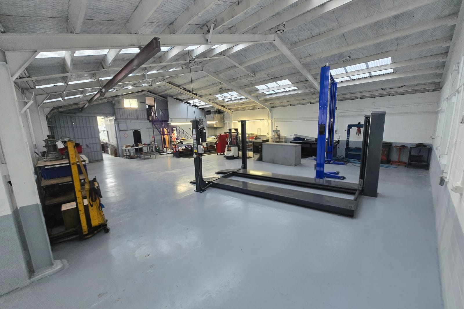 The workshop floor at Antigua Street - hoist bays under the skylights, with the stock racking beyond